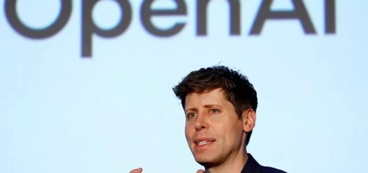 OpenAI CEO Sam Altman speaking in front of the OpenAI logo