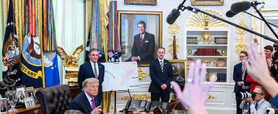 Donald Trump speaking at his White House desk with journalists and cameras present